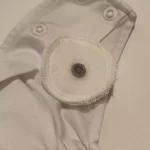 Zaščita pritiskačev na boku pralne pleničke FLIS - ženski del - 1. kos